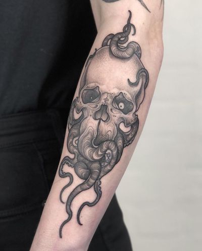 Get a unique and detailed tattoo of a skull and Cthulhu designed by artist Claudia Smith. Perfect for fans of horror and dark imagery!