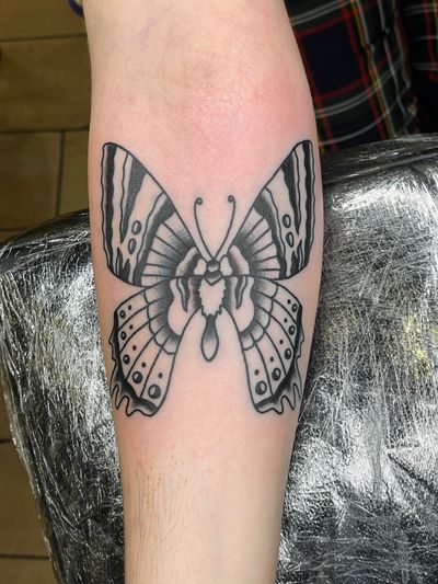Get inked with a timeless traditional butterfly tattoo from the skilled hands of Goblyn Crew. Express your inner beauty and transformation in vibrant colors and bold lines.