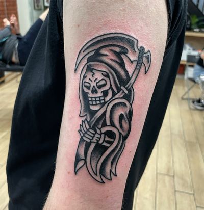 Get inked with this haunting traditional grim reaper tattoo designed by the talented artists at Goblyn Crew. Perfect for those who like dark and edgy designs.