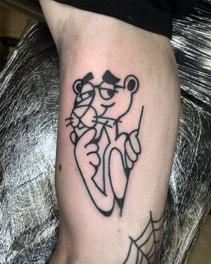 Get a playful and vibrant pink panther tattoo with detailed illustrative style by the talented artist Goblyn Crew.