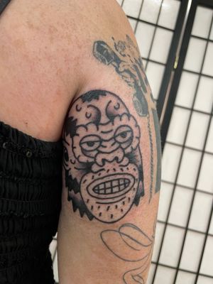 Get a fierce and bold gorilla tattoo in traditional style by the talented Goblyn Crew. Stand out with this powerful design.