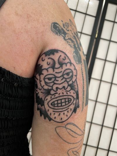 Get a fierce and bold gorilla tattoo in traditional style by the talented Goblyn Crew. Stand out with this powerful design.