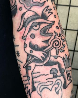 Experience traditional style with this unique frog tattoo by renowned artist Goblyn Crew. Perfect for nature lovers.
