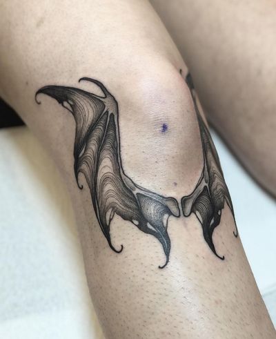 Get inked with a stunning illustrative bat wings tattoo designed by Claudia Smith for a unique and striking look