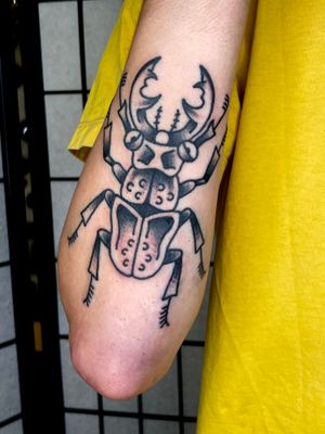 Get timeless style with a traditional beetle tattoo by the talented Goblyn Crew. This classic design is sure to make a statement.