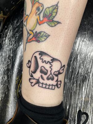 Get a bold and classic traditional skull tattoo done by the talented artist Goblyn Crew. Embrace the dark side with this timeless design.
