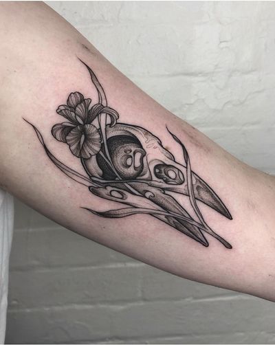 Unique dotwork tattoo combining bird, flower, and skull motifs, expertly done by the talented artist Claudia Smith.