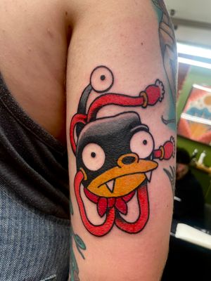 Get a vibrant and fun illustrative tattoo of The Simpsons by talented artist Goblyn Crew. Embrace your love for the iconic animated family with this unique design.