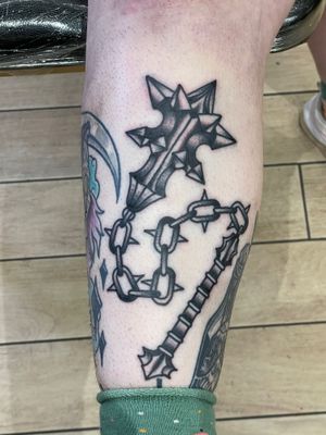 Add some medieval flair to your ink collection with a powerful weapon design by the talented Goblyn Crew. Perfect for those who appreciate traditional tattoo art.