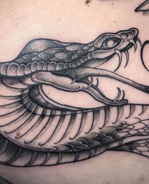 Explore the beauty of this illustrative snake tattoo designed by the talented artist Claudia Smith. Perfect for snake lovers!