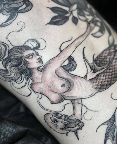 Immerse yourself in the beauty of Claudia Smith's intricate dotwork mermaid design. A captivating blend of artistry and symbolism.