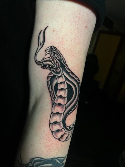 Get a striking traditional snake tattoo by the talented artist Barney Coles. Bold lines and vibrant colors guaranteed to make a statement.