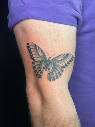 Get mesmerized by this vibrant traditional butterfly tattoo designed by DVA. Perfect for those seeking timeless beauty in body art. Book your appointment now!