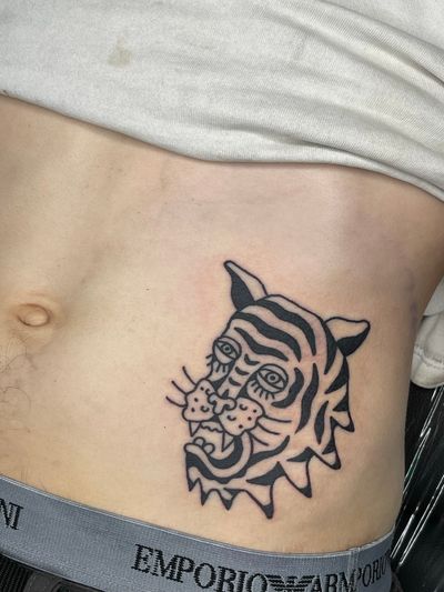 Get a fierce and beautiful traditional tiger tattoo done by the talented artist Goblyn Crew. Show off your wild side with this stunning design.