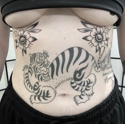 Get a fierce and majestic Japanese tiger tattoo by renowned artist Sam Waiting. Capture the strength and beauty of this iconic motif in stunning detail.