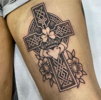 Experience a unique blend of Celtic symbolism with this illustrative cross tattoo designed by the talented artist Sam Waiting.