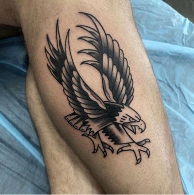 Experience the power and majesty of a traditional eagle tattoo skillfully crafted by artist Sam Waiting.