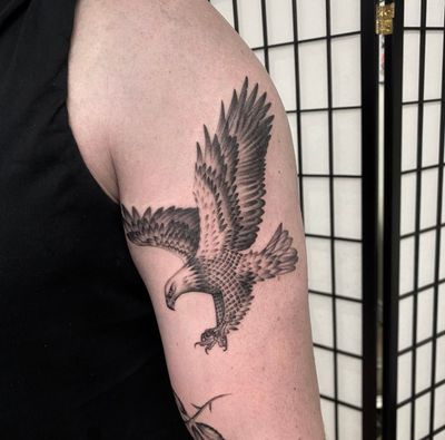 Impressive eagle portrait tattoo done by Sam Waiting, showcasing intricate details and realism.