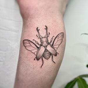 Get a unique illustrative beetle tattoo designed by the talented artist Michelle Harrison for a standout look.