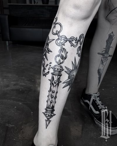 Blackwork double morning star on shin. Done in two sessions.