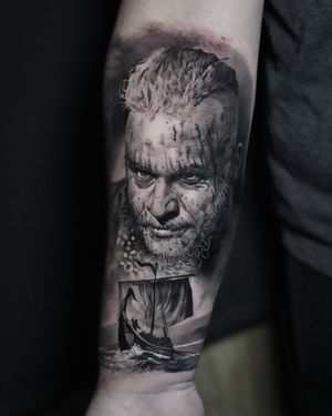 Experience the fierce and legendary Viking warrior with this stunning black and gray realism tattoo by Milan Boros.