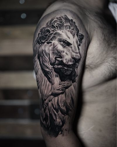 Experience the power and beauty of this stunning black and gray lion statue tattoo by Milan Boros. Realism at its finest.
