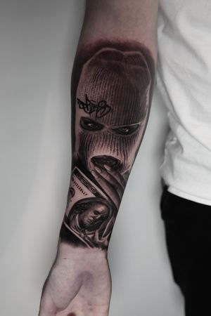 Black and gray ski mask tattoo by Milan Boros, showcasing chicano realism style.