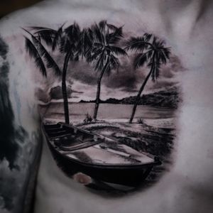 Get lost in the serene beauty of a black and gray palm tree and boat at the beach, expertly tattooed by Milan Boros.