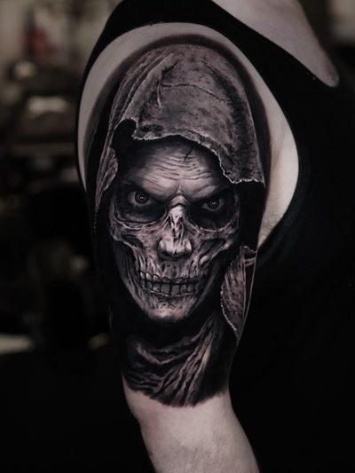 Experience the chilling presence of death with this stunning black and gray realism tattoo of the grim reaper by the talented artist Milan Boros.