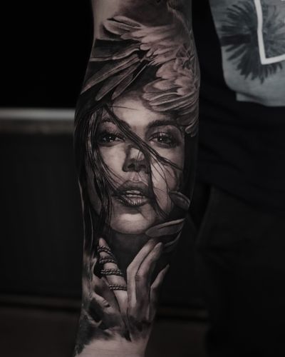 Experience the stunning realism of Milan Boros' exquisite black and gray tattoo featuring a beautiful woman. Embrace the timeless elegance of this unique artwork.