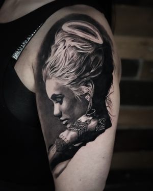 Experience the beauty and elegance of a black and gray realism portrait tattoo done by the talented artist Milan Boros.