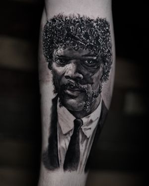 Get a realistic black and gray tattoo of Samuel L. Jackson inspired by his iconic role in Pulp Fiction, by Milan Boros.