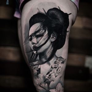Experience the elegance and grace of a geisha with this stunning black and gray realism tattoo by Milan Boros.