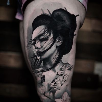 Experience the elegance and grace of a geisha with this stunning black and gray realism tattoo by Milan Boros.