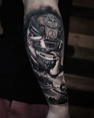 Capture the speed and precision of F1 legend Lewis Hamilton with this black and gray realism tattoo by Milan Boros.