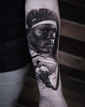 Get an incredible black and gray tattoo of 50 Cent done by the talented artist Milan Boros. Show off your love for the iconic rapper in style.
