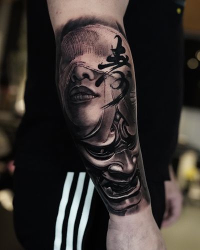 Experience the artistry of Milan Boros with this stunning black and gray tattoo featuring a geisha and hannya mask.