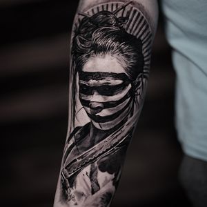 Experience the beauty of traditional Japanese art with this stunning black and gray geisha tattoo by the talented artist Milan Boros.