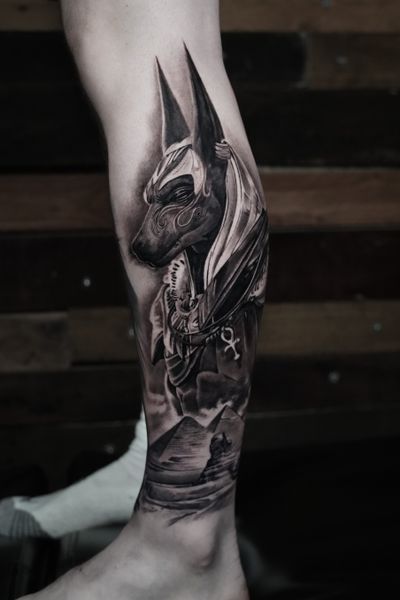 Experience the power of ancient Egypt with this stunning black and gray realism tattoo of Anubis by Milan Boros. A tribute to the god of the afterlife and protector of souls.