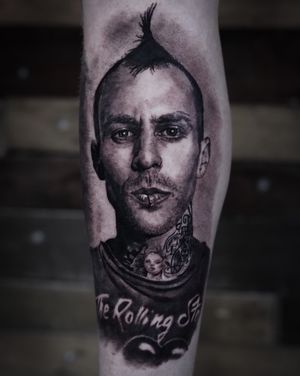 Capture the essence of Blink 182's iconic drummer with this stunning black and gray portrait tattoo by Milan Boros.