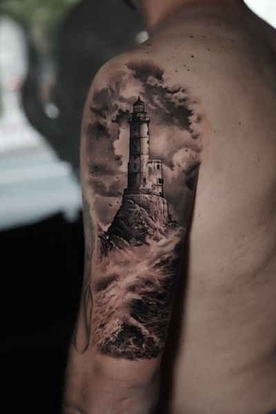 Get lost in the mesmerizing details of this black and gray lighthouse tattoo, expertly crafted by Milan Boros.