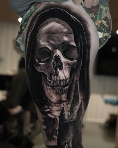 Get a hauntingly realistic black and gray tattoo of the Grim Reaper by Milan Boros. Perfect for those who embrace the darker side of life.