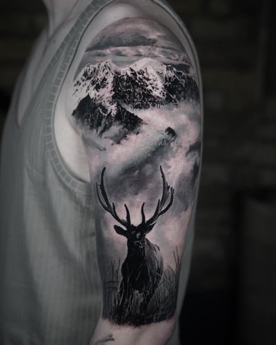 Experience the beauty of nature with this detailed black & gray tattoo featuring a majestic buck and serene mountains by Milan Boros.