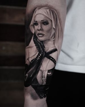 Get lost in the provocative allure of this black and gray realism tattoo by Milan Boros, featuring a sexy nun in a BDSM theme.