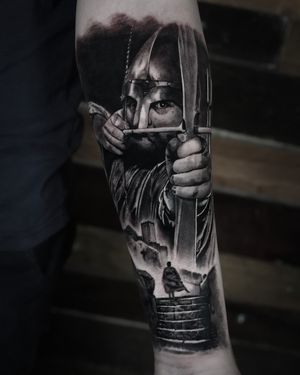 Capture the spirit of Robin Hood with this stunning tattoo by Milan Boros. Perfect for fans of archery and folklore.