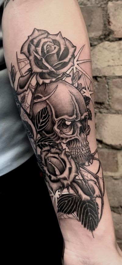 A chilling black and gray tattoo featuring a spider, rose, and skull, beautifully illustrated by Misa.