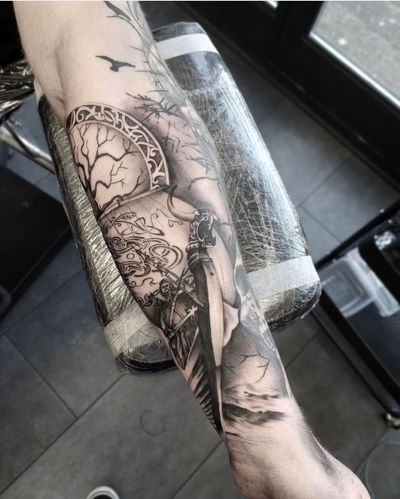 Capture the strength and courage of the ancient Norse warriors with this detailed black and gray illustrative tattoo by Tom Boxell.