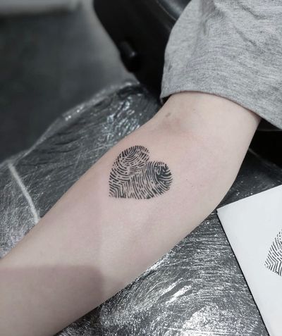 Unique and personalized illustrative tattoo design by Tom Boxell featuring a heart and fingerprint motif.
