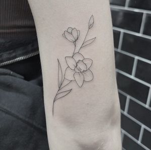 Get a stunning fine line flower tattoo created by the talented Tom Boxell for a timeless and elegant look.