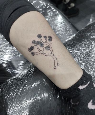 Get a stunning tree tattoo by renowned artist Tom Boxell, featuring intricate details and delicate linework.